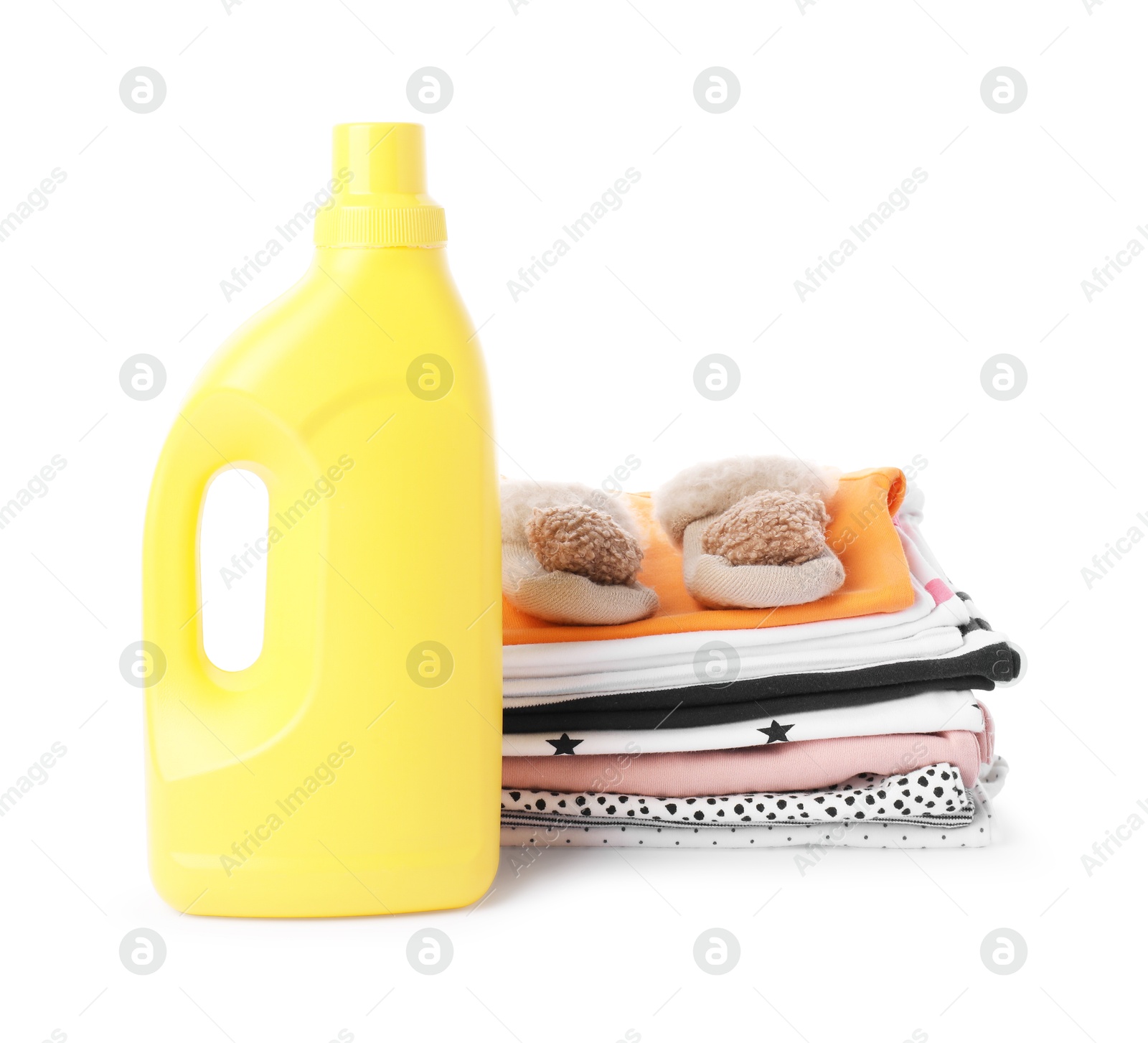 Bottle with fabric softener, shoes and baby clothes, isolated on white Photo of Bottle with fabric softener, shoes and baby clothes, isolated on white