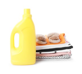 Photo of Bottle with fabric softener, shoes and baby clothes, isolated on white