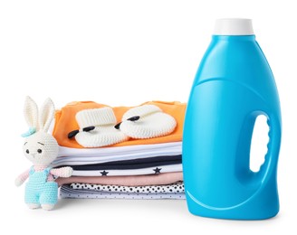 Photo of Bottle with fabric softener, shoes, baby clothes and toy isolated on white