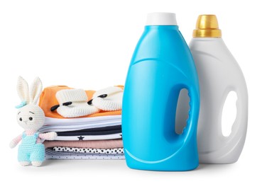 Photo of Bottles with fabric softener, shoes, baby clothes and toy isolated on white