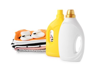 Photo of Bottles with fabric softener, shoes and baby clothes, isolated on white