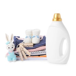 Photo of Bottle with fabric softener, shoes, baby clothes, clothespins and toy isolated on white