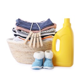 Photo of Bottle with fabric softener, shoes, basket, clothespins and baby clothes isolated on white