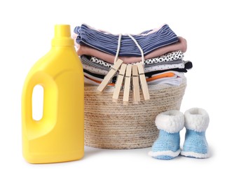 Photo of Bottle with fabric softener, shoes, basket, clothespins and baby clothes isolated on white