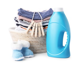 Photo of Bottle with fabric softener, shoes, basket, clothespins and baby clothes isolated on white