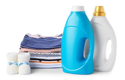 Photo of Bottles with fabric softener, shoes and baby clothes isolated on white