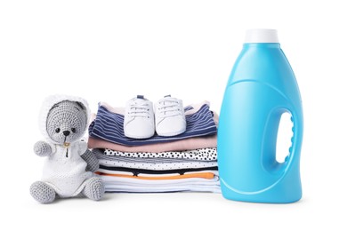 Photo of Bottle with fabric softener, shoes, baby clothes and toy isolated on white