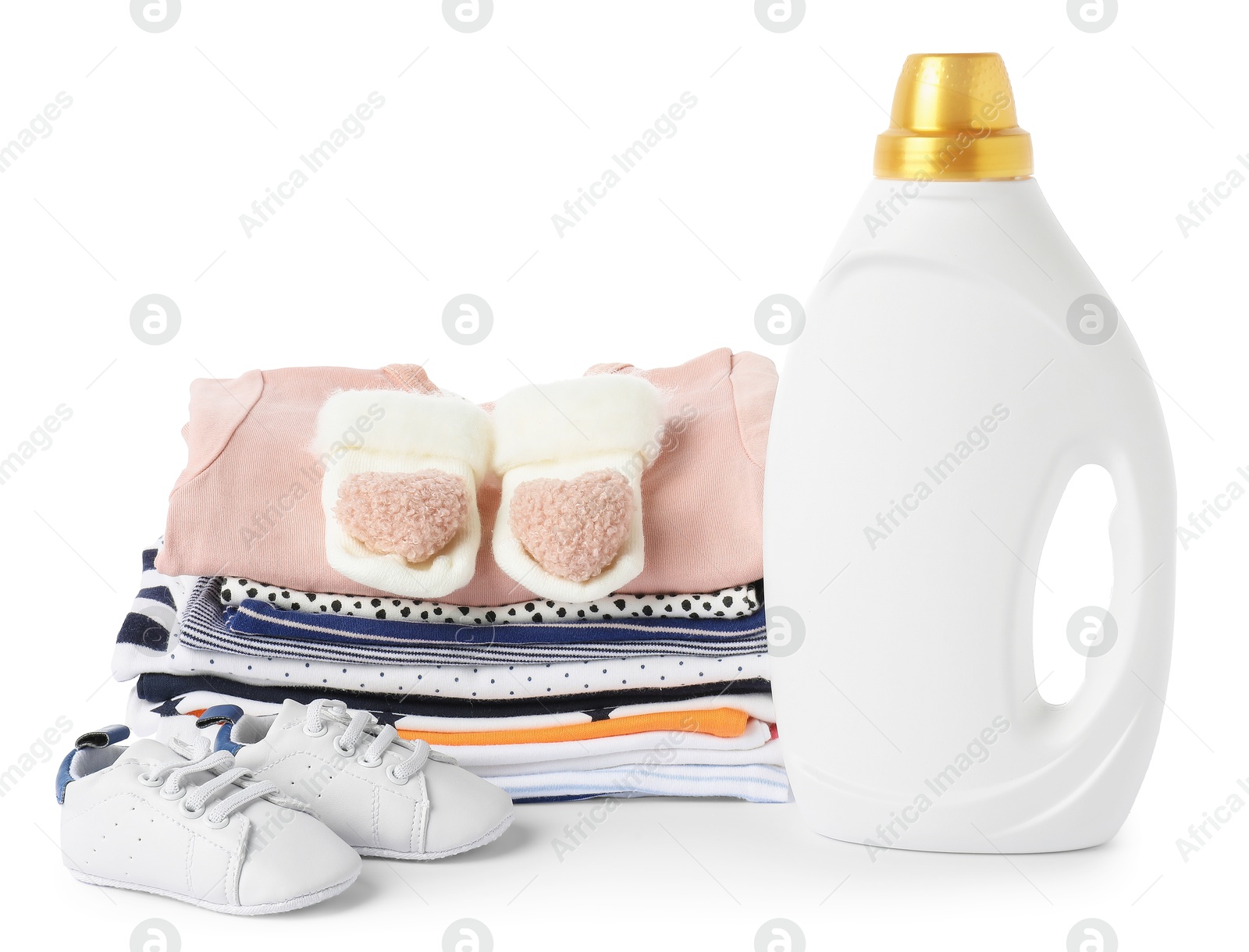 Bottle with fabric softener, shoes and baby clothes isolated on white Photo of Bottle with fabric softener, shoes and baby clothes isolated on white
