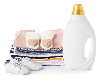 Photo of Bottle with fabric softener, shoes and baby clothes isolated on white