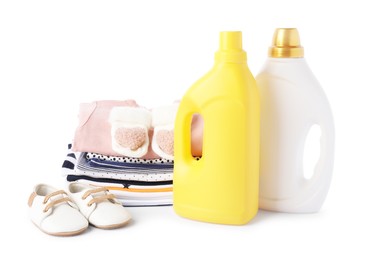 Photo of Bottles with fabric softener, shoes and baby clothes, isolated on white