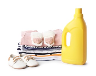 Photo of Bottle with fabric softener, shoes and baby clothes isolated on white