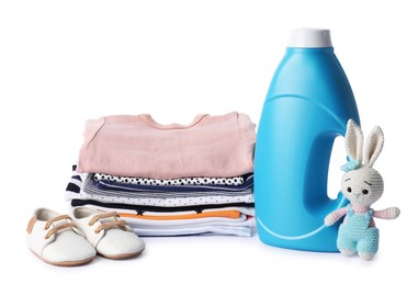 Photo of Bottle with fabric softener, shoes, baby clothes and toy isolated on white