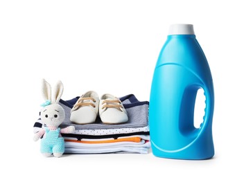 Photo of Bottle with fabric softener, shoes, baby clothes and toy isolated on white
