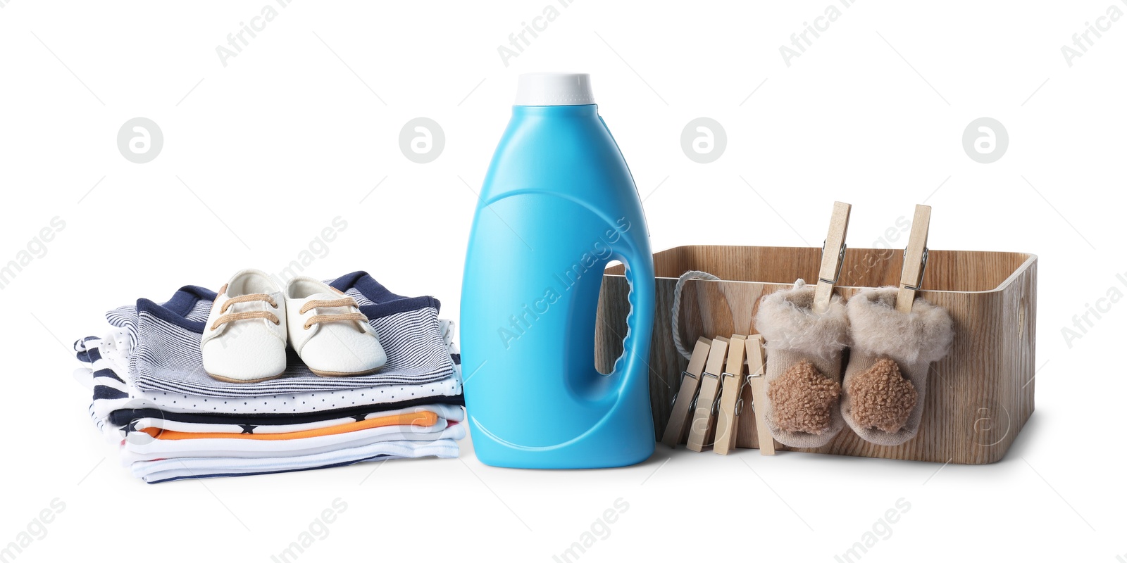 Bottle with fabric softener, shoes, basket, baby clothes and clothespins isolated on white Photo of Bottle with fabric softener, shoes, basket, baby clothes and clothespins isolated on white