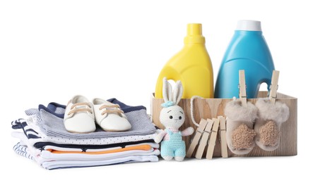 Photo of Bottles with fabric softener, shoes, baby clothes, clothespins and toy isolated on white