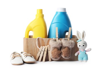 Photo of Bottles with fabric softener, shoes, baby clothes, clothespins and toy isolated on white