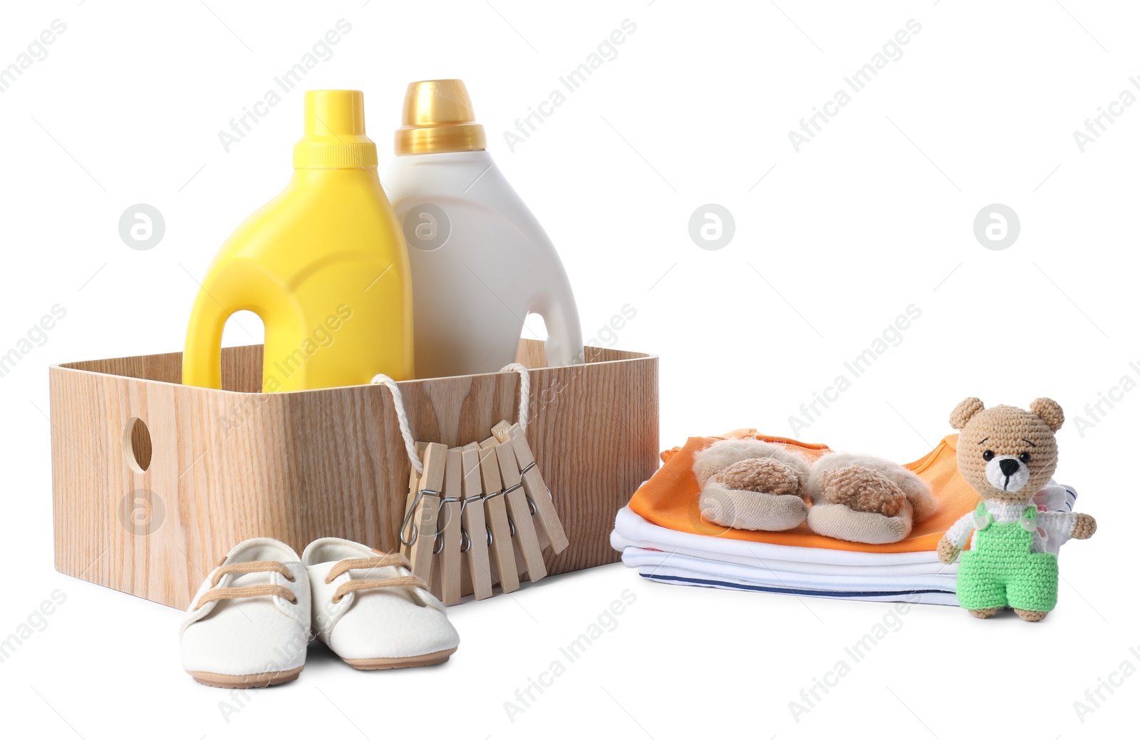 Bottles with fabric softener, shoes, baby clothes, clothespins and toy isolated on white Photo of Bottles with fabric softener, shoes, baby clothes, clothespins and toy isolated on white