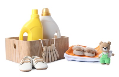 Photo of Bottles with fabric softener, shoes, baby clothes, clothespins and toy isolated on white