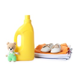 Photo of Bottle with fabric softener, shoes, baby clothes and toy isolated on white