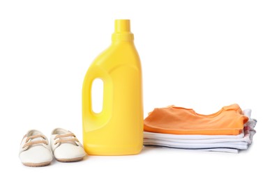 Photo of Bottle with fabric softener, shoes and baby clothes isolated on white