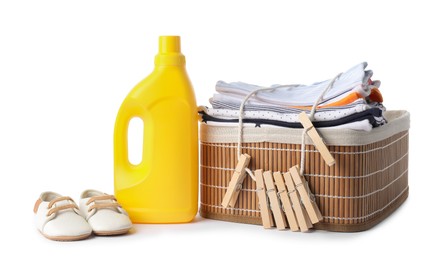 Photo of Bottle with fabric softener, shoes, basket, baby clothes and clothespins isolated on white