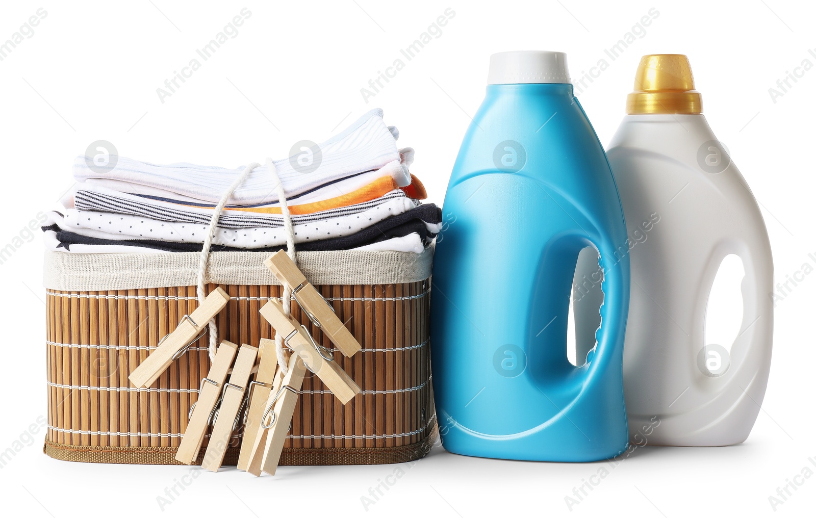 Bottles with fabric softener, basket, baby clothes and clothespins isolated on white Photo of Bottles with fabric softener, basket, baby clothes and clothespins isolated on white