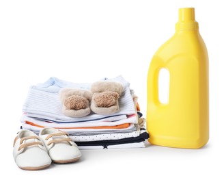 Photo of Bottle with fabric softener, shoes and baby clothes isolated on white