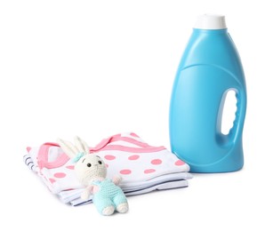 Photo of Bottle with fabric softener, baby clothes and toy isolated on white
