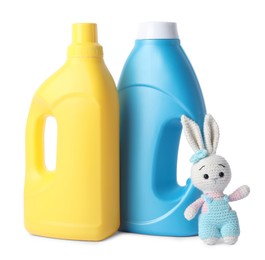Photo of Bottles with fabric softener and toy isolated on white