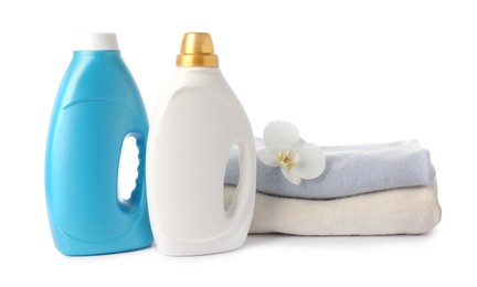 Photo of Bottles of fabric softener, stacked clothes and flower isolated on white