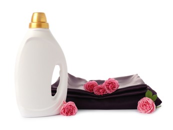 Photo of Bottle of fabric softener, stacked clothes and flowers isolated on white