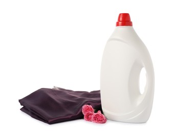 Photo of Bottle of fabric softener, stacked clothes and flowers isolated on white
