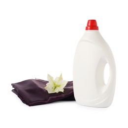 Photo of Bottle of fabric softener, stacked clothes and flower isolated on white