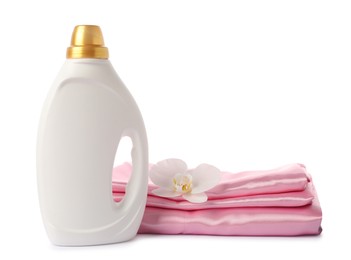 Photo of Bottle of fabric softener, stacked clothes and flower isolated on white