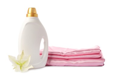 Photo of Bottle of fabric softener, stacked clothes and flower isolated on white