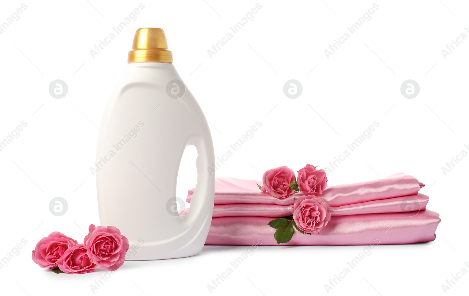 Bottle of fabric softener, stacked clothes and flowers isolated on white Photo of Bottle of fabric softener, stacked clothes and flowers isolated on white