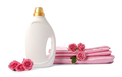 Photo of Bottle of fabric softener, stacked clothes and flowers isolated on white