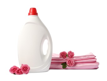 Photo of Bottle of fabric softener, stacked clothes and flowers isolated on white