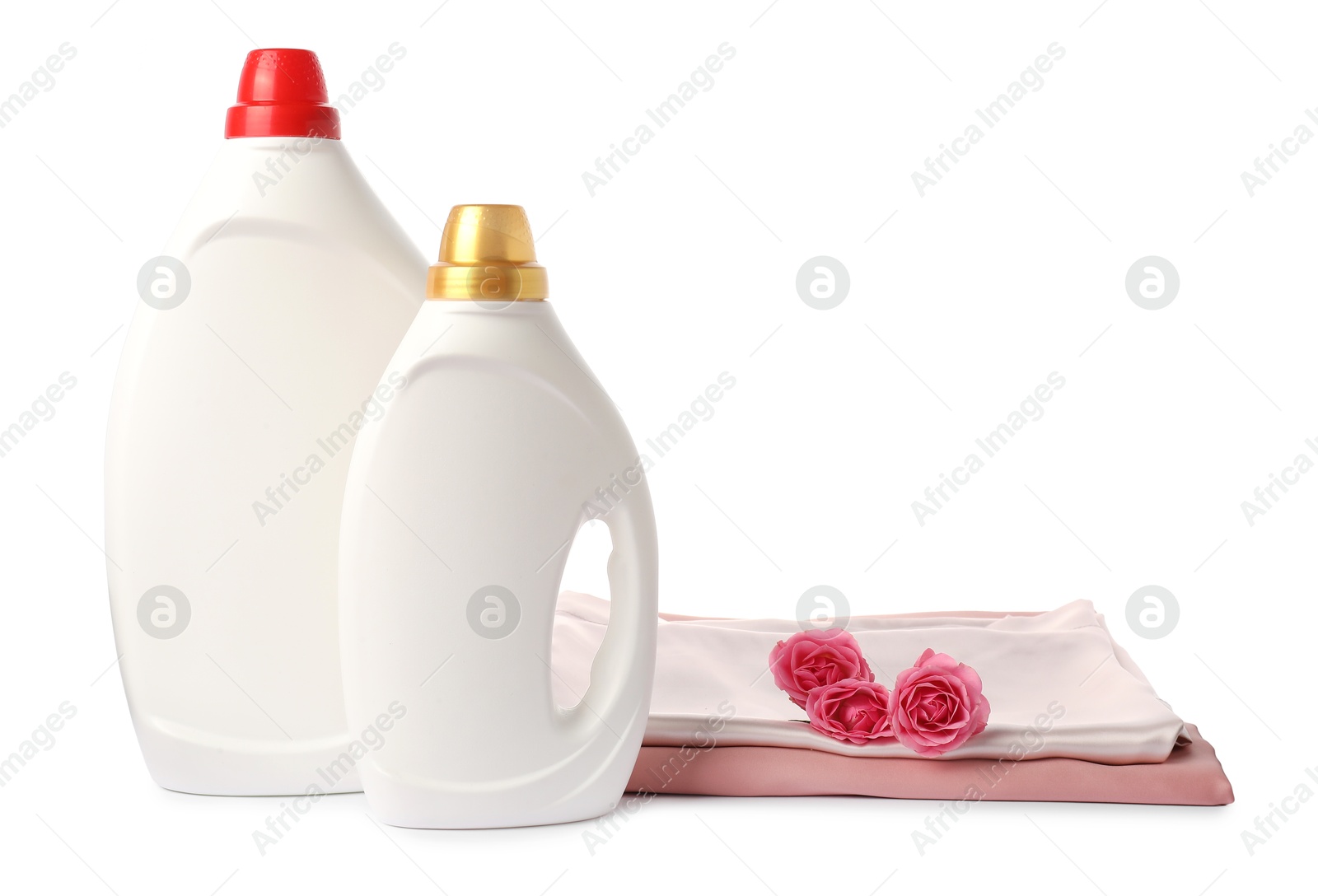 Photo of Bottles of fabric softener, stacked clothes and flowers isolated on white