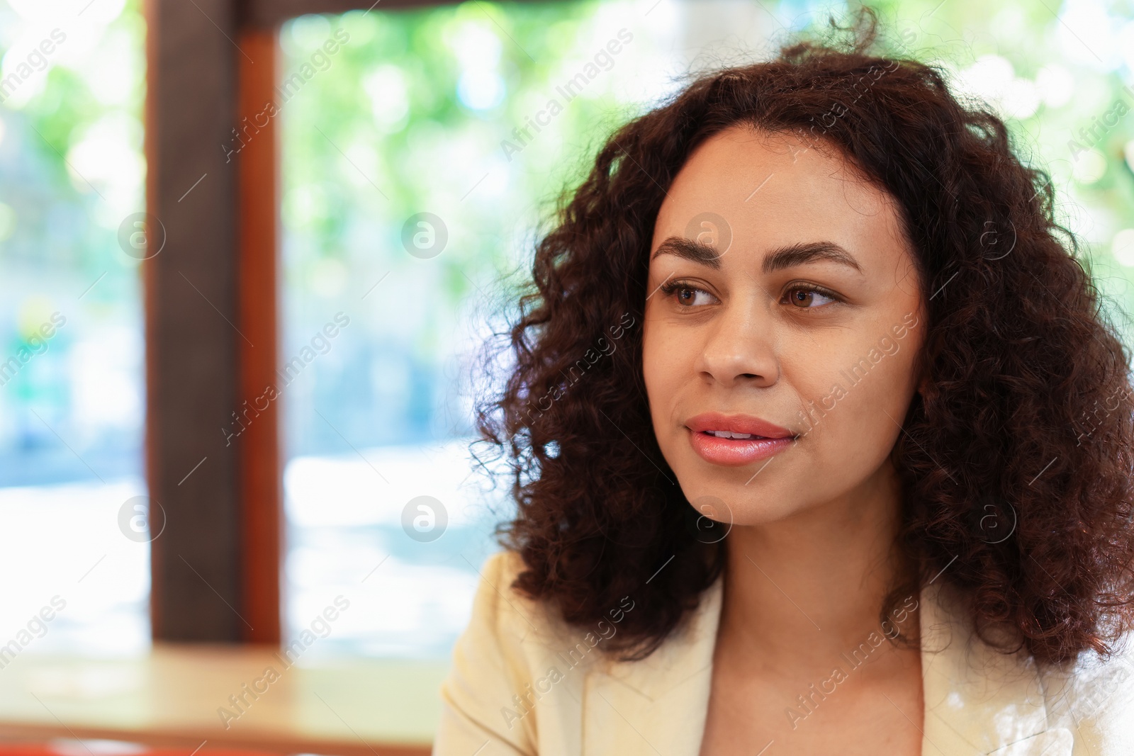 Portrait of beautiful Latin American woman in cafe. Space for text Photo of Portrait of beautiful Latin American woman in cafe. Space for text