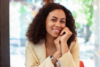 Photo of Portrait of smiling Latin American woman in cafe