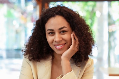 Photo of Portrait of smiling Latin American woman on blurred background