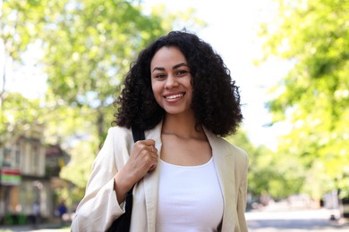Photo of Portrait of smiling Latin American woman outdoors