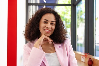 Photo of Portrait of smiling Latin American woman in cafe