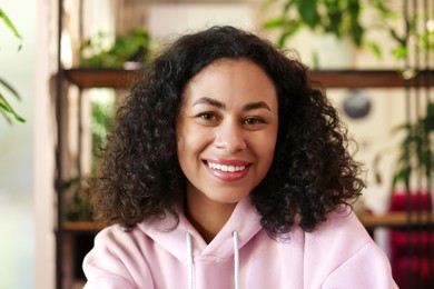 Photo of Portrait of smiling Latin American woman indoors