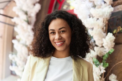 Photo of Portrait of smiling Latin American woman outdoors