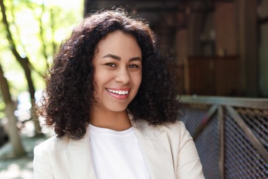 Photo of Portrait of smiling Latin American woman outdoors