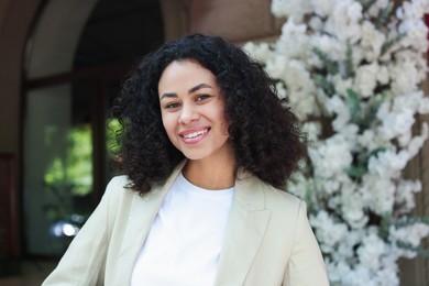 Photo of Portrait of smiling Latin American woman outdoors