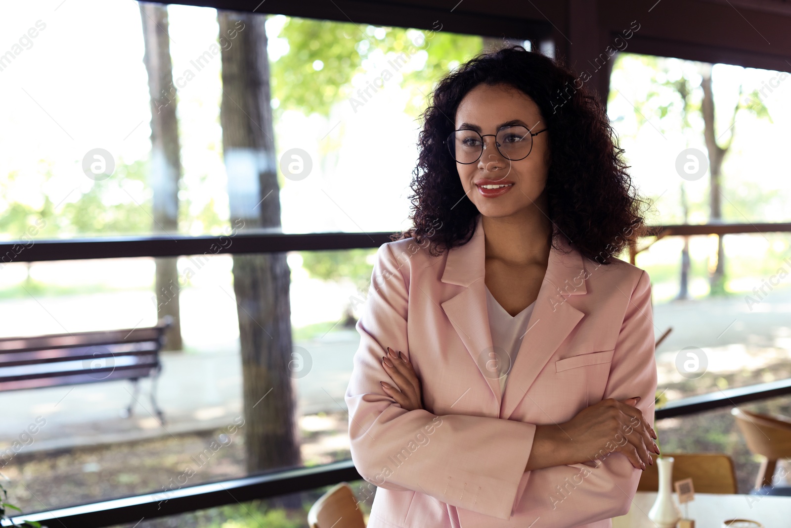 Portrait of smiling Latin American woman in cafe. Space for text Photo of Portrait of smiling Latin American woman in cafe. Space for text