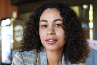 Photo of Portrait of beautiful Latin American woman on blurred background, closeup